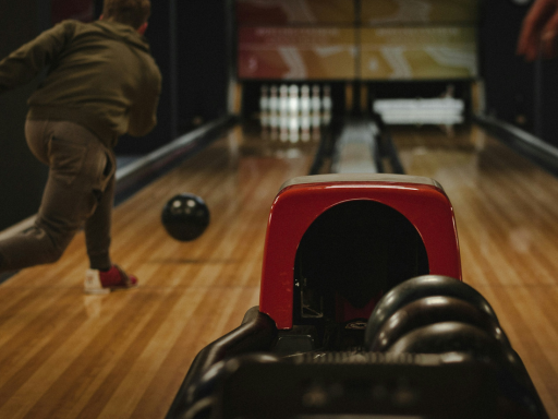 a-man-bowled-the-pins-with-black-ball